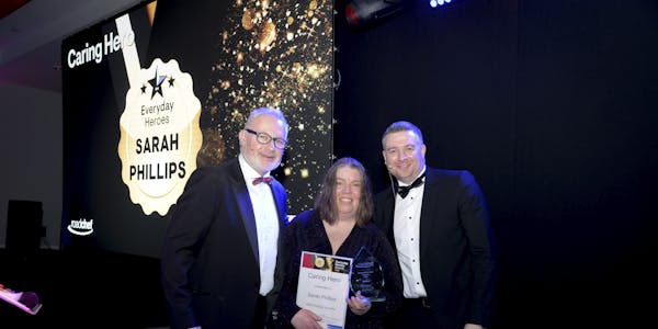 Sarah Phillips is rewarded with Caring Hero of the Year. Sarah is handed the awarded by Roadchef CEO Mark Fox and Operations Director Peter Cossar